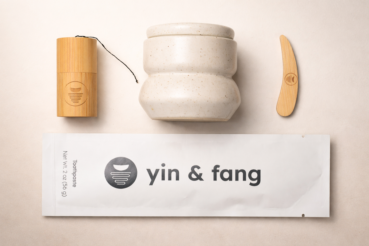 Yin & Fang Holistic Oral Health Starter Kit with ceramic container, toothpaste refill, and bamboo floss